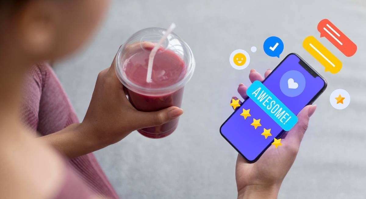 Person holding a smoothie and smartphone displaying social media reactions and likes. 